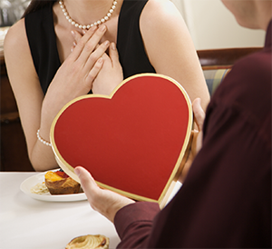 Couple with heart-shaped chocolate box